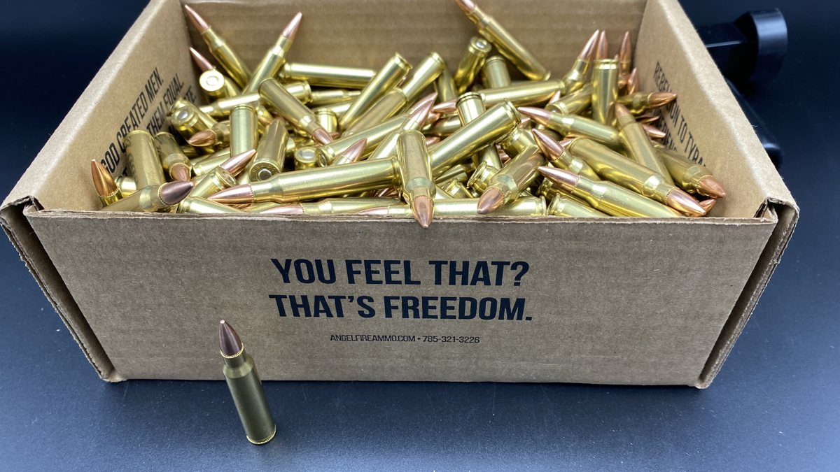 An open AngelFire box of .223 rounds with one round standing in front.